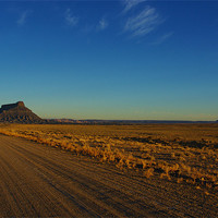 Buy canvas prints of Gravel road to Factory Butte, Utah by Claudio Del Luongo