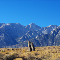 Buy canvas prints of Bizarre rock tower couple and Sierra Nevada, Calif by Claudio Del Luongo