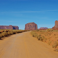 Buy canvas prints of Sand road across Monument Valley, Arizona by Claudio Del Luongo