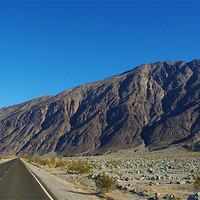 Buy canvas prints of Highway and mountains, Death Valley by Claudio Del Luongo