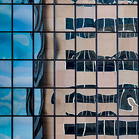 Buy canvas prints of A distorted reflection of an office block in the r by Martin Williams