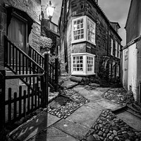 Buy canvas prints of Peacock Row in Robin Hoods Bay - Mono by Martin Williams