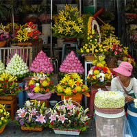 Buy canvas prints of Cambodian Flower Seller by Mark Llewellyn