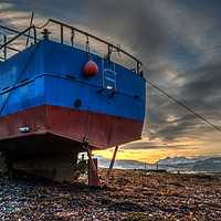 Buy canvas prints of Sunrise colour beyond a beached vessel. by Richard Smith