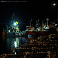 Buy canvas prints of Vessels moored to Portree pier overnight.  by Richard Smith