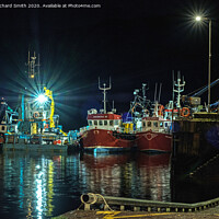 Buy canvas prints of Workboat and Trawlers moored to Portree pier at night. by Richard Smith