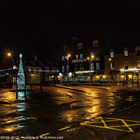 Buy canvas prints of Somerled Square, Portree with Christmas tree and lights reflected on wet pavement by Richard Smith