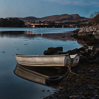 Buy canvas prints of A dinghy moored on the shore of loch Portree reflected in the water  by Richard Smith