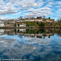 Buy canvas prints of The town of Portree surrounds the harbour with reflections of the sky. by Richard Smith