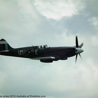 Buy canvas prints of Spitfire In The Clouds by mike jordan