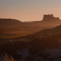 Buy canvas prints of Bamburgh Castle in the Haze by Neil Coleran