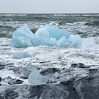 Buy canvas prints of Blue ice floe on volcanic beach by Jutta Klassen