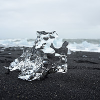 Buy canvas prints of Crystal ice on black sand by Jutta Klassen