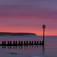 Buy canvas prints of Red Dawn over Flamborough Head  by David Hollingworth
