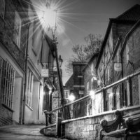 Buy canvas prints of  The Leaning Lamp post on steep hill Lincoln  by Jon Fixter