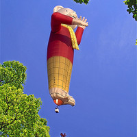 Buy canvas prints of Rupert the Bear Balloon, through trees by Peter Cope