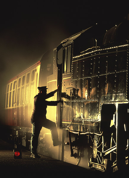 Moody silhouette as an engineman mounts his engine Picture Board by Ian Duffield