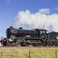 Buy canvas prints of Steam train passing on an embankment  by Ian Duffield