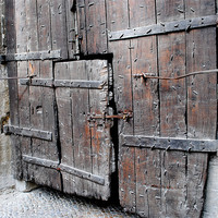 Buy canvas prints of Weathered wooden doors by Regis Yaworski
