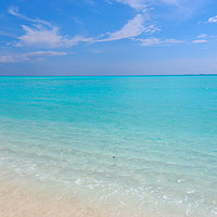 Buy canvas prints of Peaceful white sandy beach with blue ocean lagoon by Jenny Rainbow
