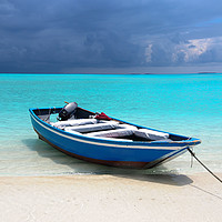 Buy canvas prints of Blue Maldivian boat on the white sand beach by Jenny Rainbow