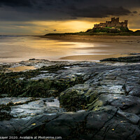 Buy canvas prints of Majestic Bamburgh Castle overlooking the North Sea by richard sayer
