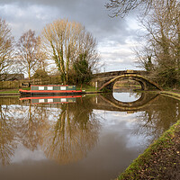 Buy canvas prints of Canal Reflections near the stone bridge by Gary Kenyon