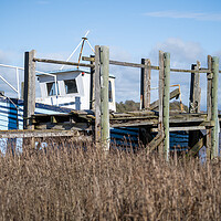 Buy canvas prints of Blue Wooden Boat at the jetty by Gary Kenyon