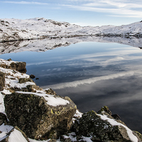 Buy canvas prints of  Snowy Stickle tarn In Winter by Gary Kenyon