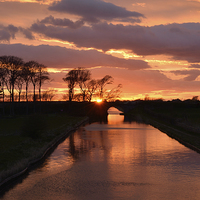 Buy canvas prints of  Sunset  And Silhouettes On The Canal  by Gary Kenyon