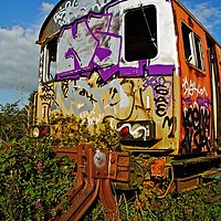 Buy canvas prints of Abandoned railway carriage covered in graffiti. by David Birchall