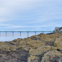 Buy canvas prints of Clevedon Pier behind the rocks by Levente Baroczi
