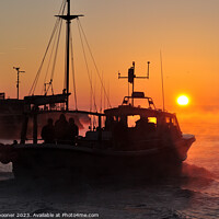 Buy canvas prints of A fishing boat heads out at sunrise by Rosie Spooner