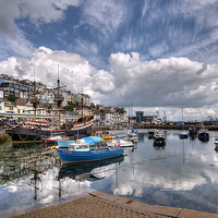 Buy canvas prints of Clouds and reflections over Brixham Harbour by Rosie Spooner