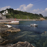 Buy canvas prints of  A boats heads out to sea at Looe by Rosie Spooner