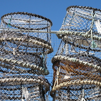 Buy canvas prints of  Lobster Pots against a blue sky by Rosie Spooner