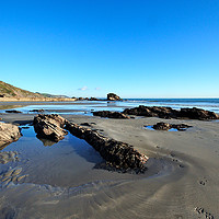 Buy canvas prints of Millendreath Beach and Black Rock at low tide by Rosie Spooner