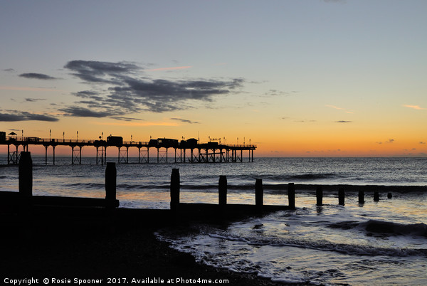 Silhouetted sunrise  of Teignmouth Pier and Groyne Picture Board by Rosie Spooner