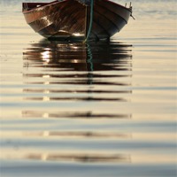 Buy canvas prints of Small Boat Reflecting At Moorings by Anne Macdonald