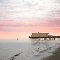 Buy canvas prints of Stunning Pink Skies Over Cleethorpes Pier at Sunse by P D