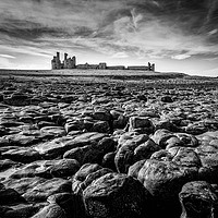 Buy canvas prints of Dunstanburgh Castle at low tide by Andy McGarry