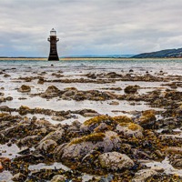 Buy canvas prints of Whitford Lighthouse At Low Tide by Eben Owen