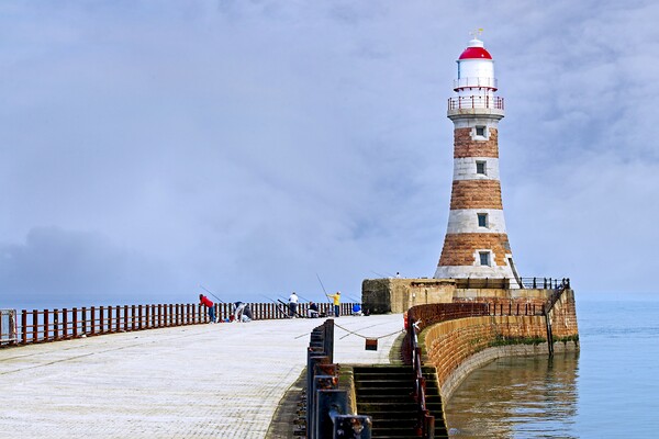 Fishing at Roker Pier and lighthouse, Sunderland Picture Board by Martyn Arnold