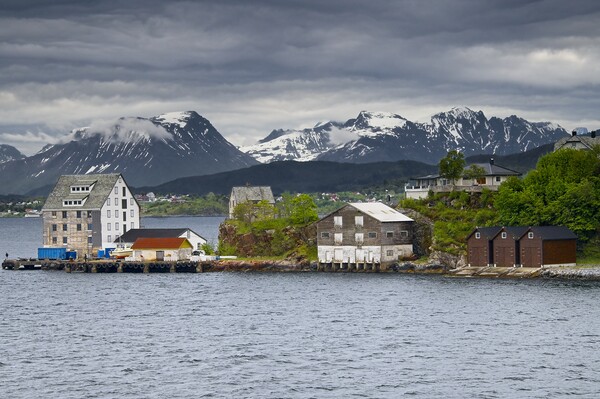 Wooden Buildings and Mountains in Alesund Norway Picture Board by Martyn Arnold