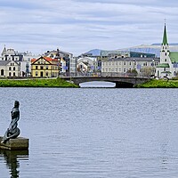 Buy canvas prints of Reykjavik Cityscape Across Tjornin Lake by Martyn Arnold