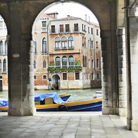 Buy canvas prints of Venice Boat through Arches by Jean Gill