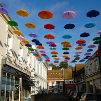Buy canvas prints of Bank Street with  umbrellas Hythe Kent  by Antoinette B