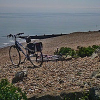 Buy canvas prints of Bicycles on the shingle beach by Antoinette B