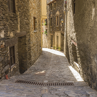 Buy canvas prints of  Cobbled Side Street in Ordino, Andorra by colin chalkley