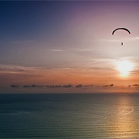 Buy canvas prints of Paragliding over Worms Head by Leighton Collins